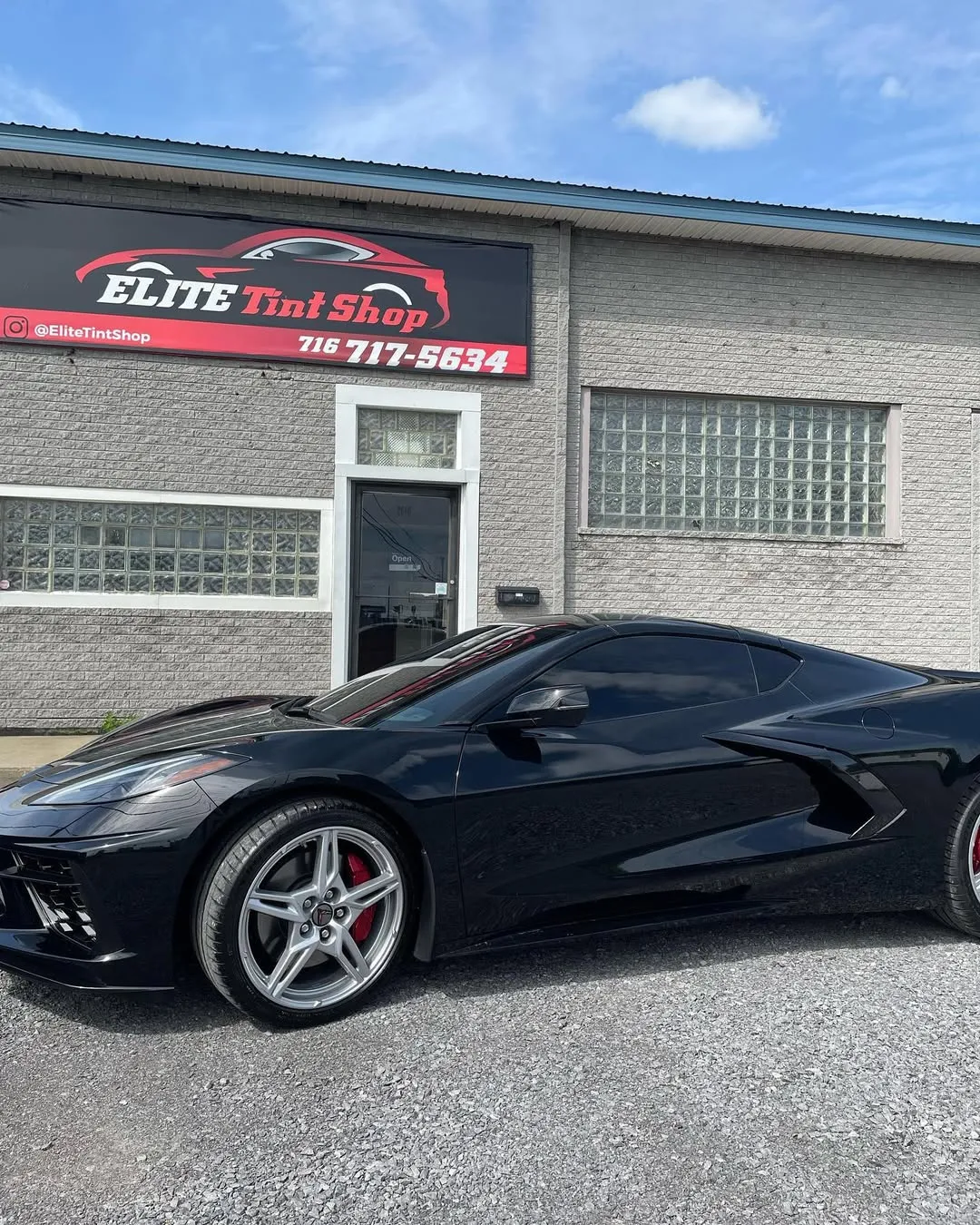 Black vehicle with premium window tint inside a dark studio